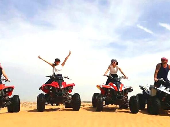 Adventure awaits: quad biking across beautiful desert dunes.
